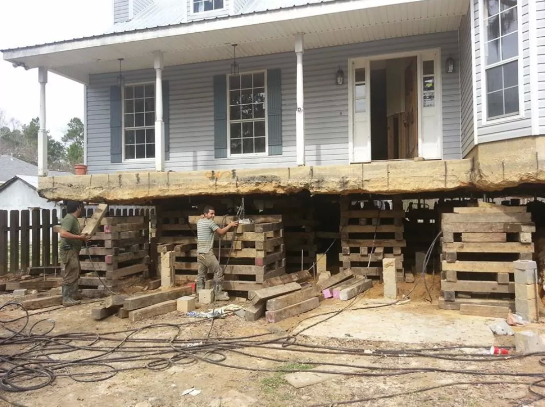A Best Foundation Repair house leveling project using cribbing and jacks in Houston
