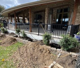 Open trench running along the porch foundation partway through the lift
