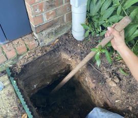 Digging out beneath the downspout so roof water gets carried away from the foundation