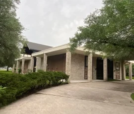 Completed foundation repair project with the exterior grounds and concrete areas restored around the building. The property is clean and finished following the foundation work.