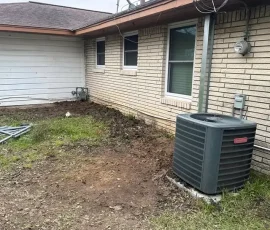 Residential foundation perimeter after repair with excavated areas backfilled and the work site restored. The completed foundation project leaves the area clean following stabilization.