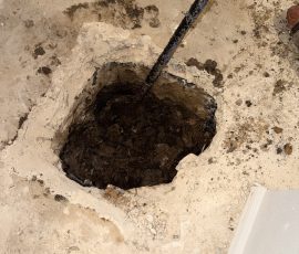 Interior slab opened up so we could set an interior pier during a house leveling job