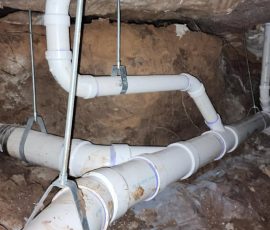 Pipework running through the crawl space, reworked around the pier and beam repair