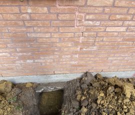 The stair-step crack in this brick wall is exactly what brought us out, with the pier going in below it